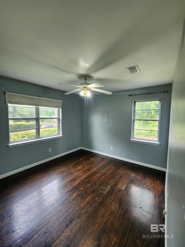 unfurnished room featuring a wealth of natural light, hardwood / wood-style floors, and ceiling fan