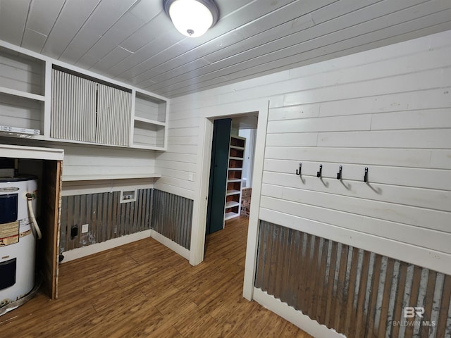 interior space with dark wood-type flooring and water heater