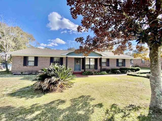 ranch-style home with a front lawn and brick siding