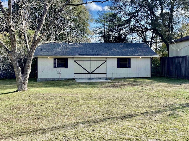 view of outbuilding featuring fence
