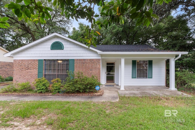 5645 Green Tree Rd, Mobile, AL 36609 - single story home featuring a porch, brick siding, and a front yard