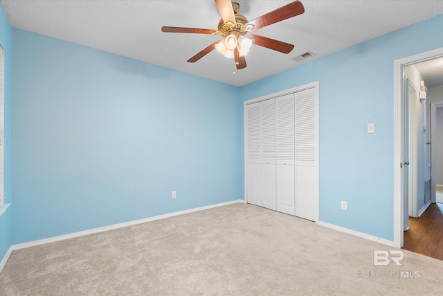 5645 Green Tree Rd, Mobile, AL 36609 - unfurnished bedroom with carpet floors, a closet, baseboards, and a ceiling fan