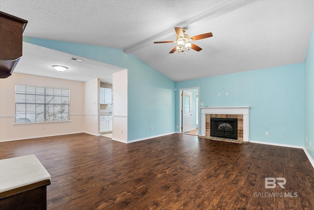 5645 Green Tree Rd, Mobile, AL 36609 - unfurnished living room with wood finished floors, a ceiling fan, baseboards, a tiled fireplace, and a textured ceiling