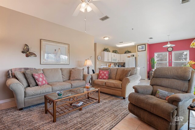 living room with ceiling fan and light tile patterned floors