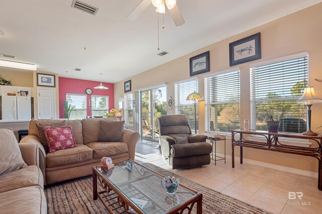 tiled living room featuring ceiling fan