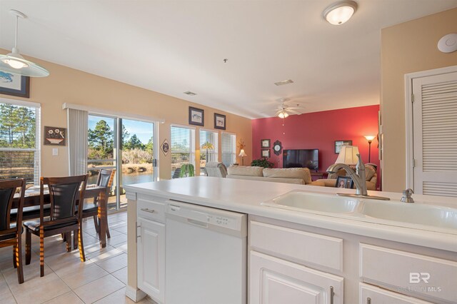 kitchen with white dishwasher, sink, ceiling fan, decorative light fixtures, and white cabinetry