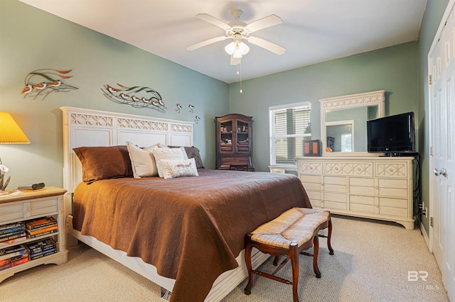 bedroom featuring ceiling fan, light carpet, and a closet