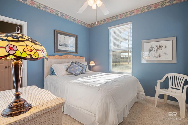 bedroom with ceiling fan and light carpet