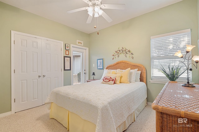 bedroom featuring light carpet, a closet, and ceiling fan