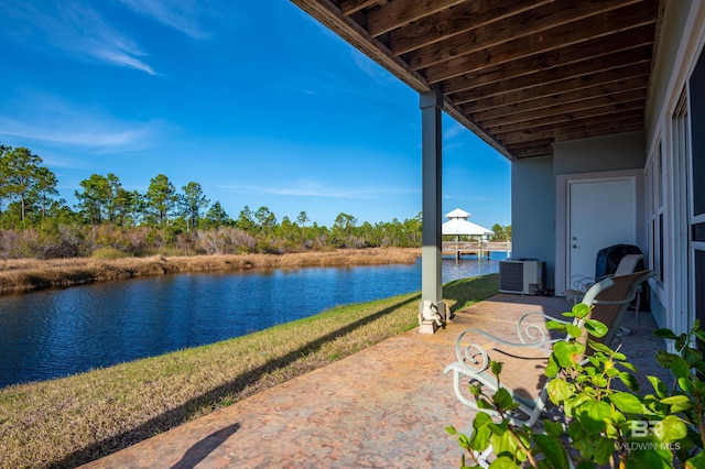 view of patio featuring cooling unit and a water view