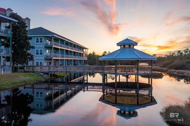 view of dock with a gazebo and a water view