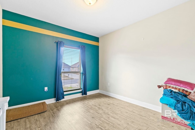 empty room with hardwood / wood-style flooring