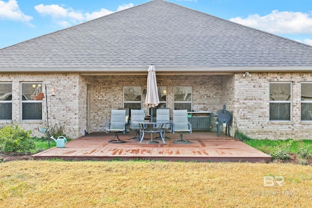 back of property featuring a yard and a deck