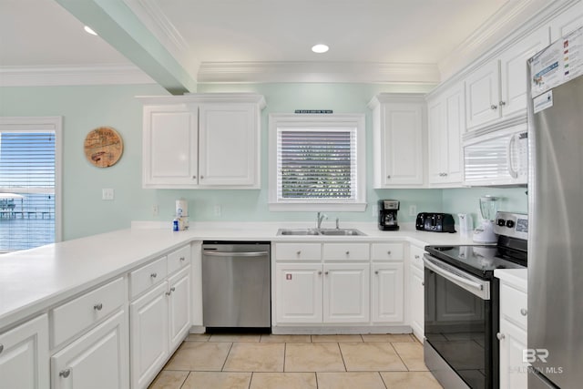 kitchen with light tile patterned floors, stainless steel appliances, and white cabinets