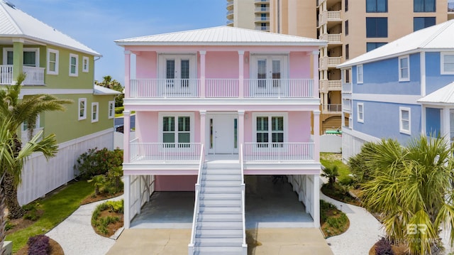 beach home featuring french doors and a balcony