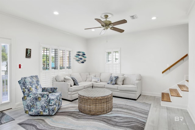 living room with ceiling fan, light hardwood / wood-style floors, and ornamental molding