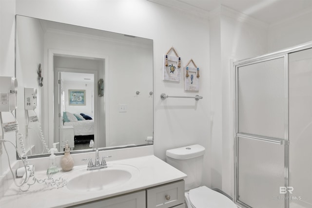 bathroom with vanity, ornamental molding, an enclosed shower, and toilet