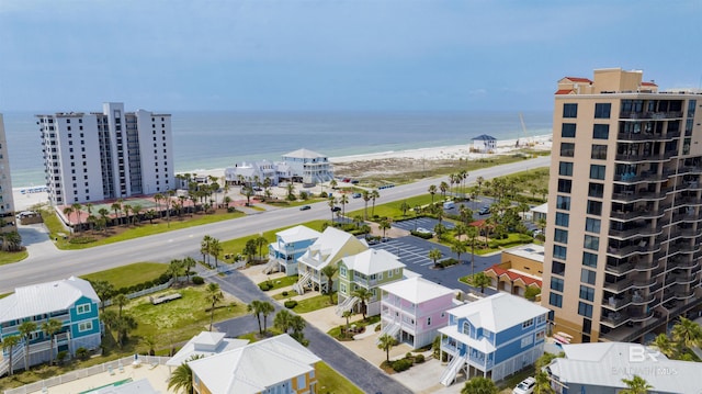 birds eye view of property featuring a water view and a beach view