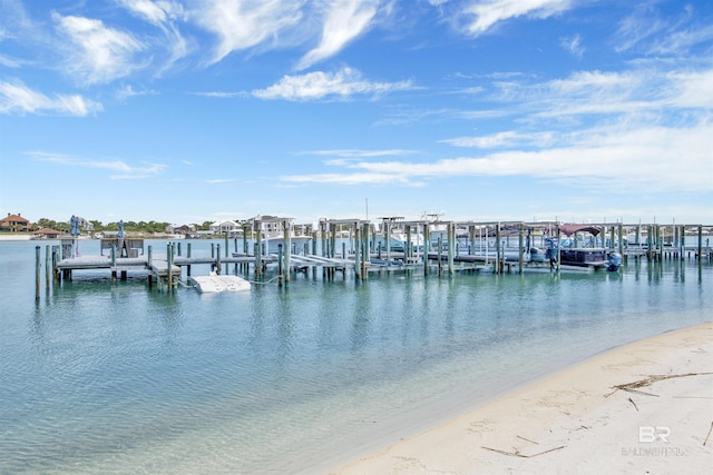 dock area with a water view and a beach view