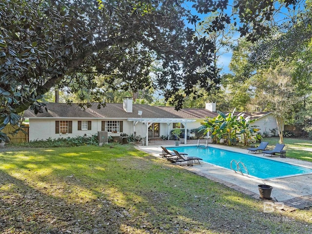 view of pool with a yard, central AC, and a patio area