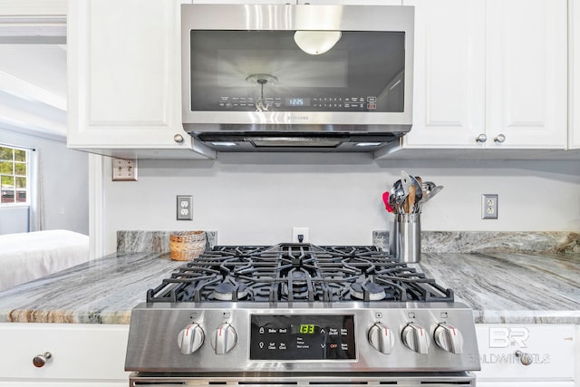 room details featuring light stone countertops, white cabinetry, and appliances with stainless steel finishes