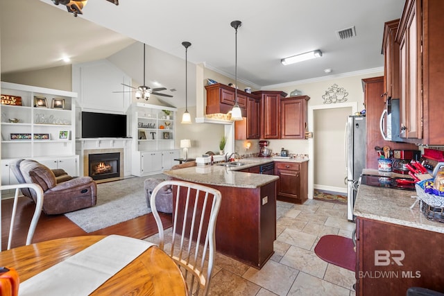 kitchen featuring appliances with stainless steel finishes, hanging light fixtures, ceiling fan, vaulted ceiling, and a breakfast bar