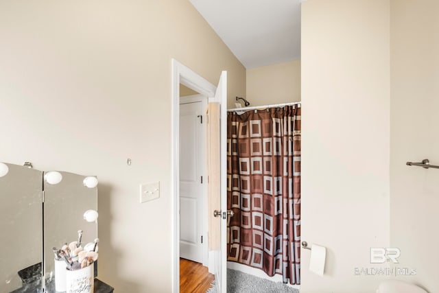 bathroom featuring hardwood / wood-style floors and a shower with shower curtain