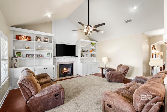 living room featuring ceiling fan, hardwood / wood-style flooring, high vaulted ceiling, and a fireplace