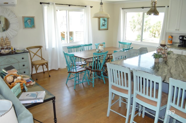 220 Shoreland Cir, Gulf Shores, AL 36542 - dining room featuring plenty of natural light, light hardwood / wood-style floors, crown molding, and a wall mounted AC