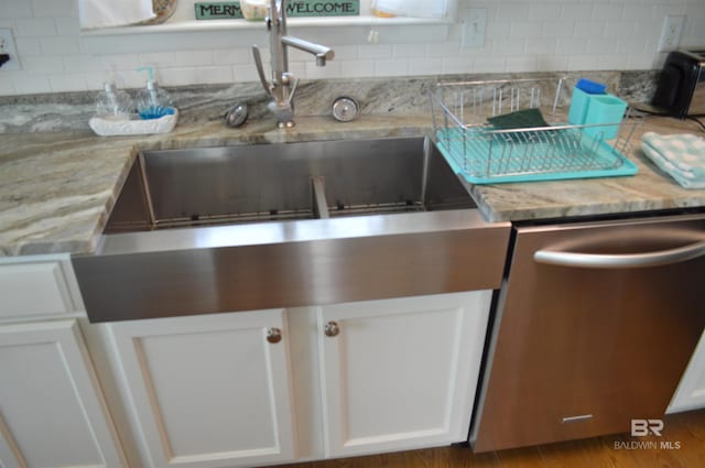 220 Shoreland Cir, Gulf Shores, AL 36542 - kitchen with dishwasher, white cabinets, light stone countertops, and sink