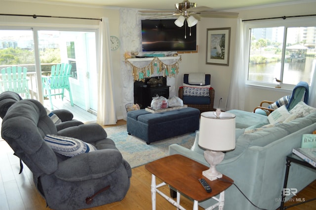 220 Shoreland Cir, Gulf Shores, AL 36542 - living room with plenty of natural light, ceiling fan, crown molding, and light hardwood / wood-style flooring