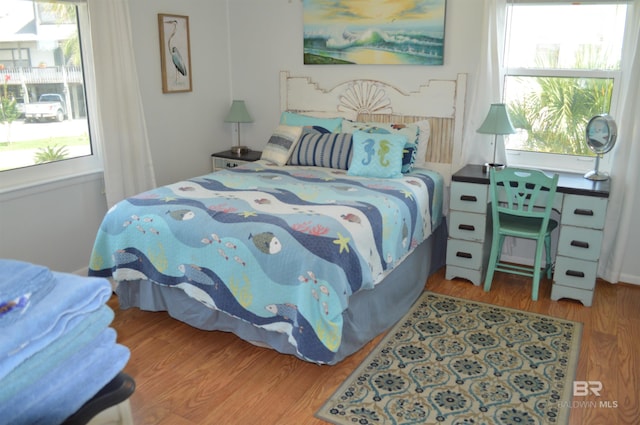 220 Shoreland Cir, Gulf Shores, AL 36542 - bedroom with hardwood / wood-style floors and multiple windows