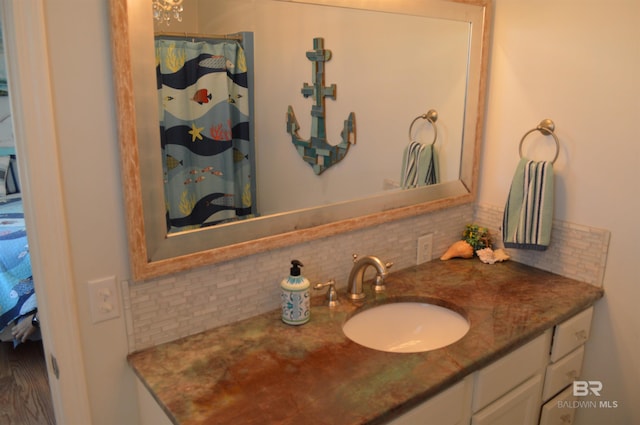 220 Shoreland Cir, Gulf Shores, AL 36542 - bathroom featuring vanity and backsplash