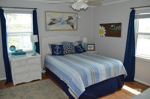 220 Shoreland Cir, Gulf Shores, AL 36542 - bedroom featuring hardwood / wood-style flooring, ceiling fan, and multiple windows