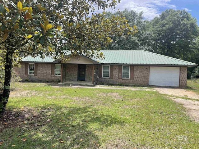 8115 Centeridge Dr, Wilmer, AL 36587 - ranch-style home with dirt driveway, a front lawn, an attached garage, brick siding, and metal roof