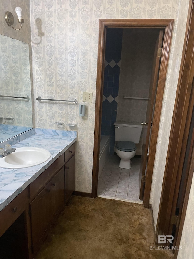 8115 Centeridge Dr, Wilmer, AL 36587 - bathroom with vanity, toilet, wallpapered walls, and a tub to relax in