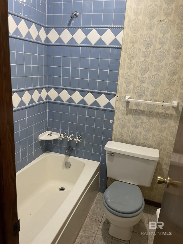 8115 Centeridge Dr, Wilmer, AL 36587 - bathroom with a bath, toilet, and tile patterned floors