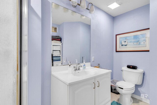 310 W 3rd Ave, Gulf Shores, AL 36542 - bathroom with toilet, vanity, tile patterned floors, and baseboards