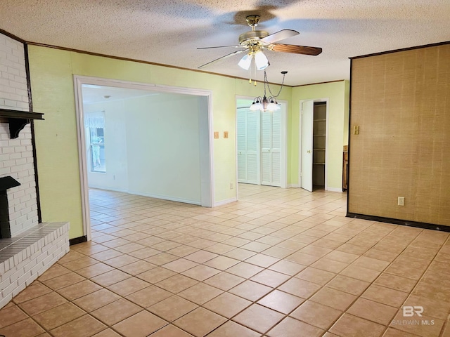 6120 Appaloosa Dr, Mobile, AL 36693 - unfurnished room with a ceiling fan, crown molding, light tile patterned floors, a fireplace, and a textured ceiling