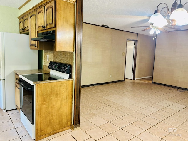 6120 Appaloosa Dr, Mobile, AL 36693 - kitchen with range with electric cooktop, under cabinet range hood, light tile patterned flooring, a ceiling fan, and a textured ceiling