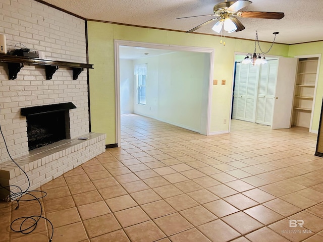 6120 Appaloosa Dr, Mobile, AL 36693 - unfurnished living room with ceiling fan, a textured ceiling, light tile patterned floors, ornamental molding, and a brick fireplace