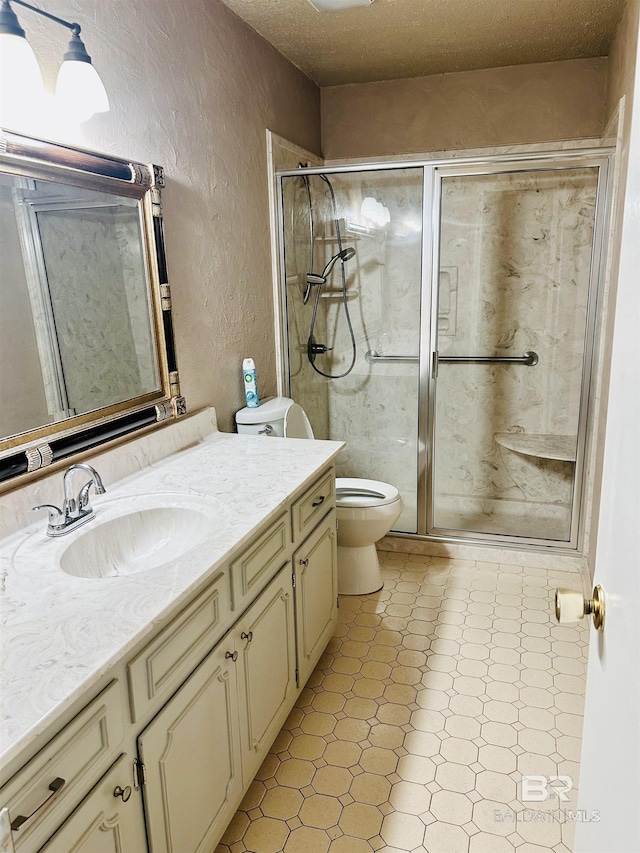 6120 Appaloosa Dr, Mobile, AL 36693 - full bathroom featuring a textured wall, tile patterned floors, toilet, a shower stall, and vanity
