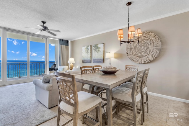 527 E Beach Blvd Unit 802, Gulf Shores, AL 36542 - dining area with a chandelier, crown molding, expansive windows, a textured ceiling, and a ceiling fan