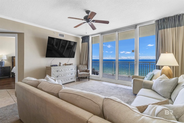 527 E Beach Blvd Unit 802, Gulf Shores, AL 36542 - living area with floor to ceiling windows, tile patterned floors, ceiling fan, a textured ceiling, and ornamental molding