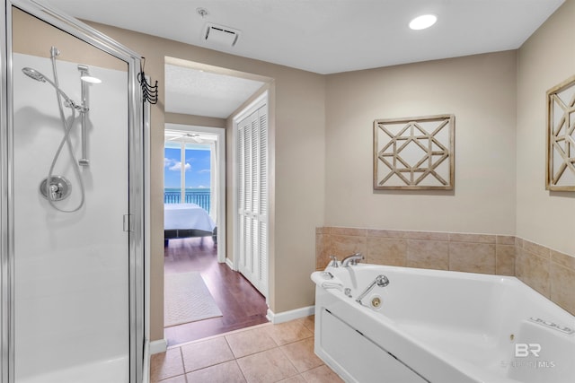 527 E Beach Blvd Unit 802, Gulf Shores, AL 36542 - bathroom featuring a tub with jets, a shower stall, tile patterned floors, and recessed lighting