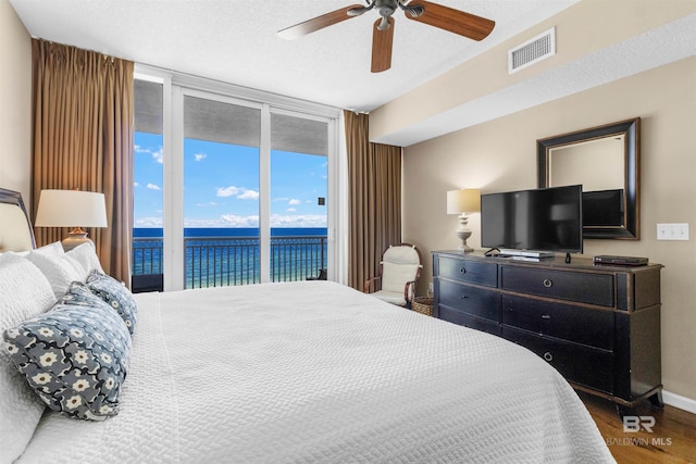 527 E Beach Blvd Unit 802, Gulf Shores, AL 36542 - bedroom featuring floor to ceiling windows, access to outside, wood finished floors, and a ceiling fan