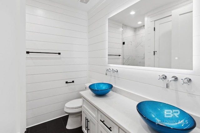 1438 Bienville Blvd Unit B, Dauphin Island, AL 36528 - bathroom featuring toilet, vanity, an enclosed shower, tile patterned floors, and wooden walls