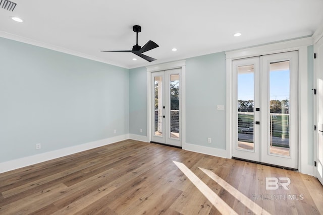1438 Bienville Blvd Unit B, Dauphin Island, AL 36528 - spare room featuring french doors, baseboards, crown molding, light wood finished floors, and ceiling fan