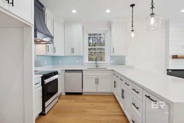 1438 Bienville Blvd Unit B, Dauphin Island, AL 36528 - kitchen with dishwasher, wall chimney exhaust hood, black / electric stove, a peninsula, and a sink