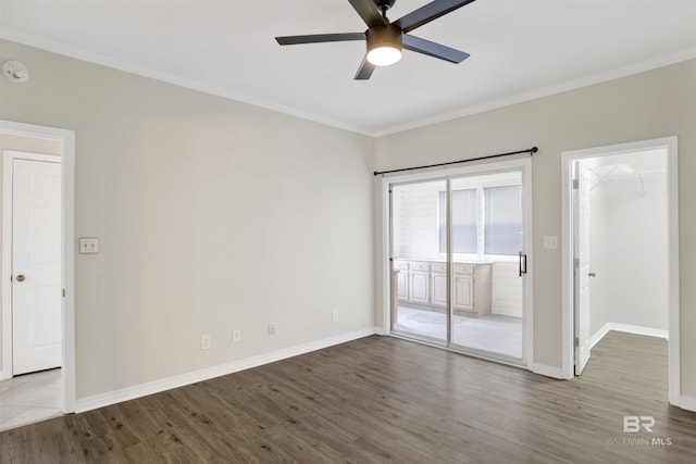 unfurnished room featuring ceiling fan, wood-type flooring, and ornamental molding